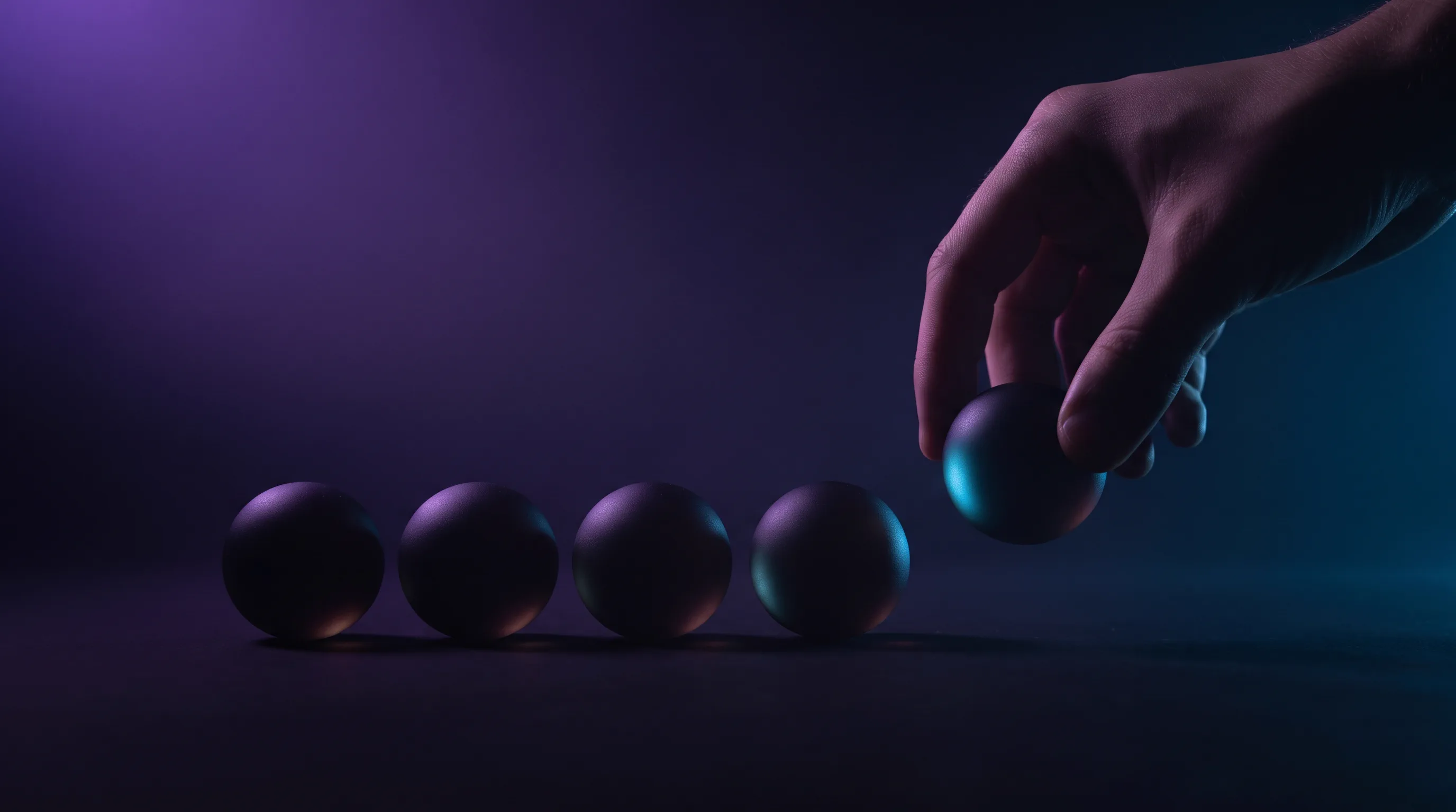 A hand placing the next sphere at the end of an ordered row